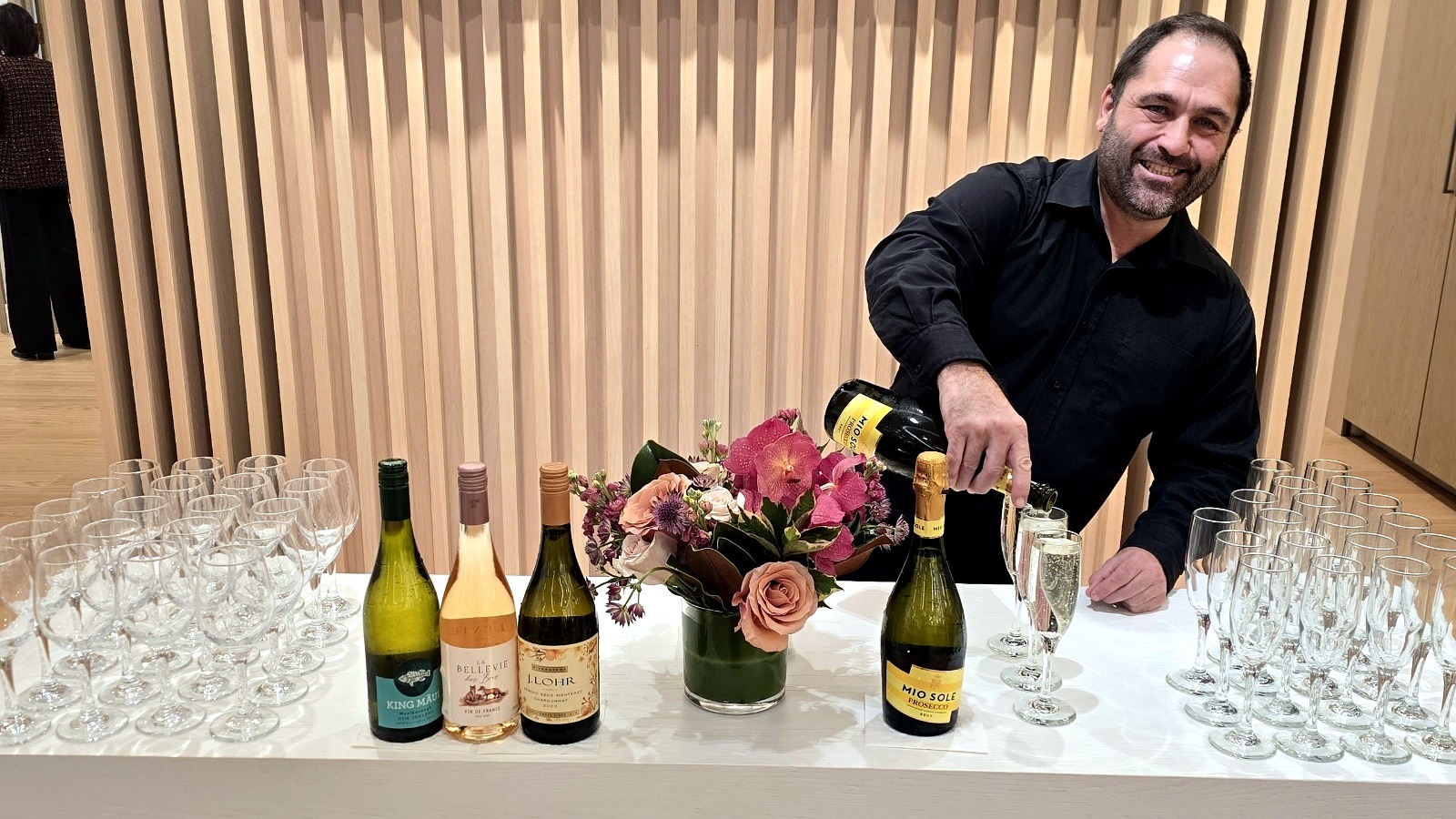 Bartender serving guests at a private home event